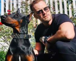 He has adopted a Doberman and believes that this breed is the boss of all other dog breed.