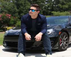 Elan is also a car enthusiast and often photographs himself in front of luxurious cars.