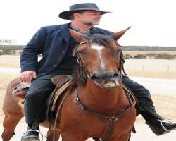 He rides his own horse named honey in the movie 