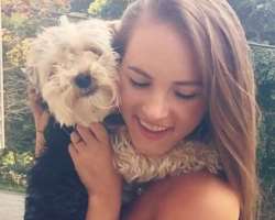The star has adopted a dog and cuddles him to show her love.