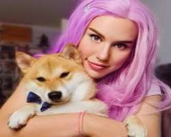 She has adopted a dog in her home and cuddles him to show her love.