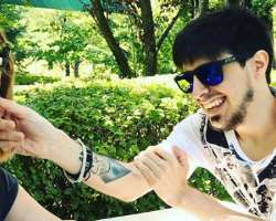 He has a tattoo on his right wrist.