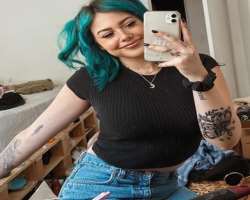 She has multiple tattoos on arms, leg, and neck.